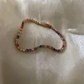 Élégant bracelet tennis doré avec cristaux ronds multicolores arc-en-ciel sur de la soie - Style Rond Multicolore Entièrement Sertis de Strass / Or