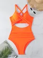 Macro view of the neon orange one-piece swimsuit with cross-front cutout detail. - Orange