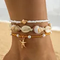 Boho enkelbandjesset met witte kralen, schelpen en gouden zeester hanger om de enkel - Enkelbandje / Meerlaagse Combinatie / Goud
