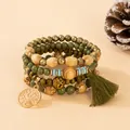 Detailed macro view of Bohemian multi-layer wood bead bracelet with life tree charm and tassel. - Green