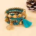 Detailed view of bohemian multi-layer bracelet with tree of life charm and teal tassel. - Lake Blue