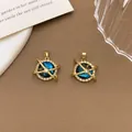 Elegant gold dreamy planet pendant with blue starry sky pattern and crystal halo - XL1365 Crossed Planet Pendant Gold