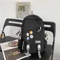 Black large capacity backpack with fashion badges and printed straps for school students. - Black