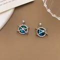 Dreamy planet pendant with blue nebula center and sparkling crystal star ring accents - XL1365 Crossed Planet Pendant Silver