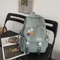 Grey-green large capacity school backpack with decorative badges and buckle straps - Blue