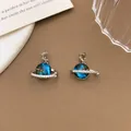 Dreamy blue galaxy planet pendant featuring a silver moon and sparkling rhinestone ring. - XL2222 Moon Planet Pendant Silver