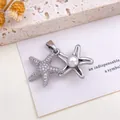 Elegant silver starfish pendant with shimmering crystals and a central pearl accent - Starfish Pearl Pendant (XL795) / Silver