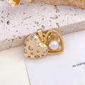 Elegant gold heart locket pendant featuring sparkling crystals and a white pearl accent. - Heart Pearl Pendant (XL2580) / Gold