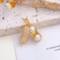 Gold peanut pendant jewelry featuring white pearls and sparkling crystal pavé accents - Small Peanut Pearl Pendant (XL2726) / Gold