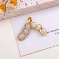 Elegant gold peanut and pea pod pendant featuring sparkling crystals and white pearls - Three Peanuts Pearl Pendant (XL2814) / Gold
