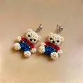 Macro detailed view of handmade beaded bear earrings featuring red, blue and white beads - Stud Earrings / Multicolor