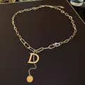 Elegant gold chain necklace with a large D initial pendant and crystal accents - Letter D Style / Gold