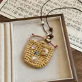 Close-up of a vacation style woven pendant necklace with shells and pearls on leather cord. - Woven Square Bag Style (1 Necklace-Coffee)