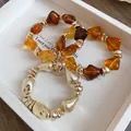 Vintage geometric amber resin and gold-tone metal beaded bracelets in a white box - Amber Irregular Bead Chain Set (24) / Three-Piece Set / Gold Brown