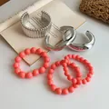 Stack of vintage silver metallic bangles and coral pink beaded stretch bracelets set - Coral Pink Bead Silver Bangle Set (40) / 6-Piece Set / Silver-Pink