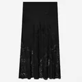 Detail view of black satin midi skirt with exquisite floral lace patchwork. - XS / Bottoms / Black