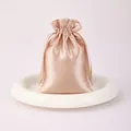 Elegant champagne rose gold satin drawstring gift pouch for jewelry and luxury packaging. - Champagne