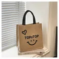 Primo piano di una borsa in juta alla moda con stampa TOPnTOP e grazioso cuore - Piccola Faccina Sorridente A Forma Di Cuore / Dimensioni Piccole: 26*27*14 Dimensioni Grandi: 34*30*17