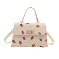 Cream corduroy small square crossbody bag with red strawberry print pattern design. - White