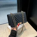 Elegant black quilted crossbody bag with gold chain strap and premium turn-lock closure - Black