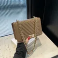 Elegant brown V-quilted shoulder bag with a classic gold chain and metal lock closure - Brown