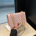 Elegant pink quilted crossbody bag with stylish gold lock and chain strap design. - Aurora Pink