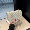 Elegant white pearl-sheen quilted chain shoulder bag featuring gold-tone lock closure - Aurora White