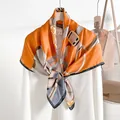 Elegant orange silk scarf with floral and buckle print displayed on white shirt - Orange / 88*88cm