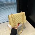 Stylish light yellow quilted square shoulder bag with elegant gold chain strap and lock - Yellow