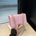 Elegant pink quilted crossbody bag with gold chain strap and stylish twist-lock closure - Pink