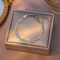 Elegant two-tone gold and silver twisted snake chain bracelet made of durable titanium steel - Bracelet / Gold and Steel Tone Bracelet