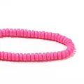 Close-up macro detail of vibrant hot pink polymer clay heishi beads for DIY jewelry - Pink