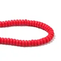 Close-up of bright red polymer clay flat round spacer beads for handmade DIY jewelry - Red