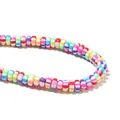 Detailed macro shot of candy-colored striped polymer clay spacer beads for DIY jewelry - Multicolor