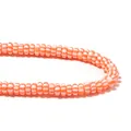 Detail shot of orange and white striped polymer clay flat round spacer beads for DIY jewelry - Orange and White