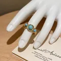 Close-up detail of golden ethnic style open ring with three faux-turquoise stones - Triple Artificial Turquoise Style