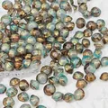 Macro view of 8x10mm saucer-shaped glass beads with vintage gold and turquoise textures - Saucer Bead 6# (8x10mm) / Dawn