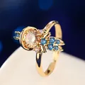 Close-up macro view of a gold fairy tale princess ring set with colorful gemstones. - Elf Wings Champagne Style (R05512-01) / Gold