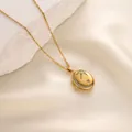Close-up of gold celestial oval locket necklace with moon and star zircon details - Star Moon Pattern Style (t1519-j) / Gold