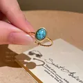 Vintage style gold-toned adjustable open ring featuring an oval faux turquoise stone. - Small Artificial Turquoise Style