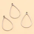 Gros plan sur trois cadres ouverts en acier inoxydable en forme de goutte pour bijoux DIY. - Goutte d'eau - Large / 12X27X1.2mm / Acier
