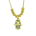 Macro detail of 18K gold-plated Hamsa hand necklace pendant with blue cubic zirconia - Hollow Hamsa (DN260602-H)