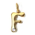 Close-up of a gold stainless steel letter F pendant with a clear birthstone detail. - Letter F