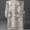 Elegant beige hand-embroidered floral scarf with tassels draped over a chair for winter warmth - Embroidered Snowdrop Flower - Beige / 70-200cm