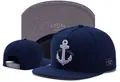 Classic navy blue snapback cap featuring white anchor embroidery and flat brim detail - Style 131 / Adjustable