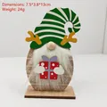 Detailed view of a wooden Christmas gnome figurine with antlers and a long white beard - Green Striped Hat Antler Gnome With Gift Box