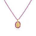 Primer plano de un medallón ovalado dorado de la Virgen María con cuentas moradas - Oro Rosa Rojo Strass