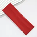 Macro view of wide red elastic headband with fine knit fabric texture detail. - Red