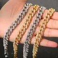 Detailed view of four iced out gold and silver Cuban link necklaces held in hand - Necklace / 60CM / Silver
