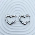Detailed view of textured silver-tone heart-shaped stainless steel hoop earrings - 18K Gold / Silver Hammered Heart (101)
